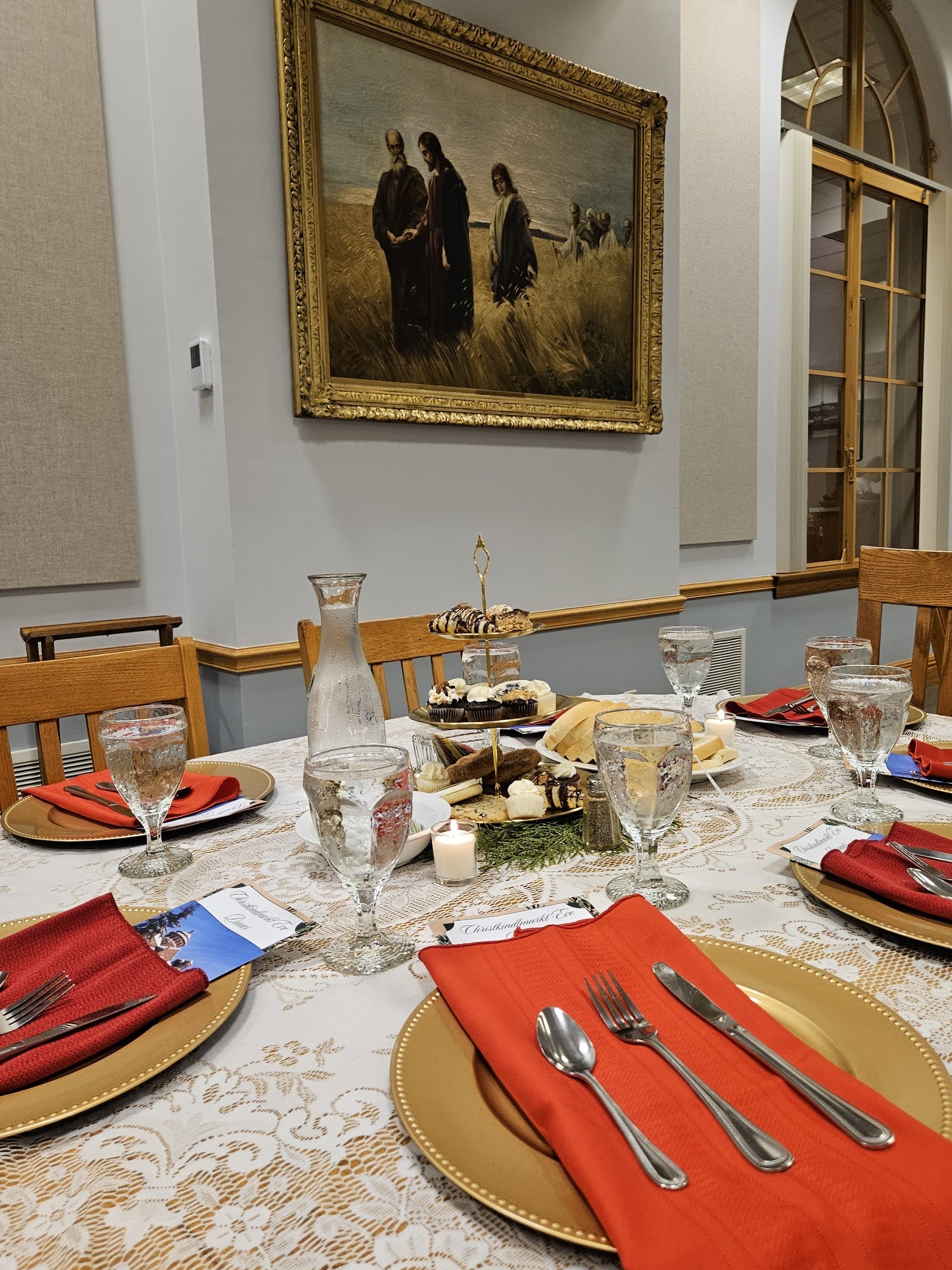 Guests seated at a long candlelit dinner table